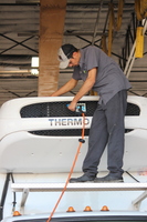 Ismael cleaning a Thermo King truck unit