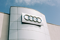Audi Rings on dealership exterior.