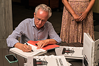 Horacio Pagani signing books at a Pagani dinner event