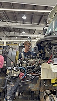 Younger tech working on a truck in one of the bays