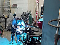 Our techs come with many different skills and backgrounds. This tech was caught welding a piece for some equipment in our shop. 