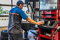 Technician working with Hunter Revolution Tire Machine