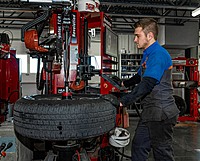 Technician working with Hunter Revolution Tire Machine