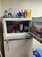 Freezer is stocked with snacks and meals.