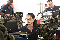 Automotive Service students diagnosing engines in the lab