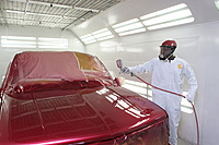 Automotive Collision Technology student painting a vehicle in the booth