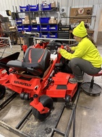 Kennedy putting together a new lawn mower. 