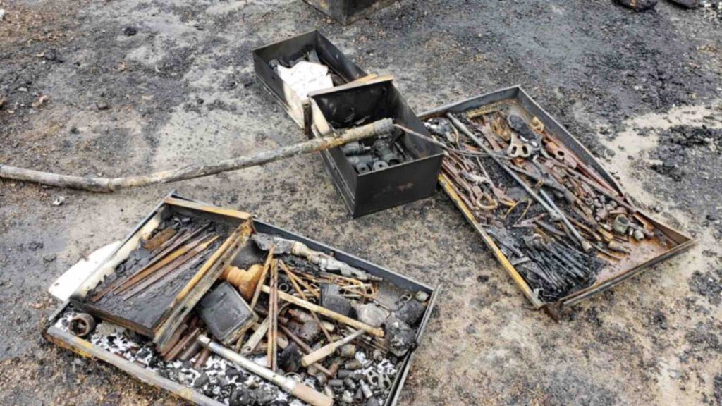 Pile of burnt tools and equipment from shop