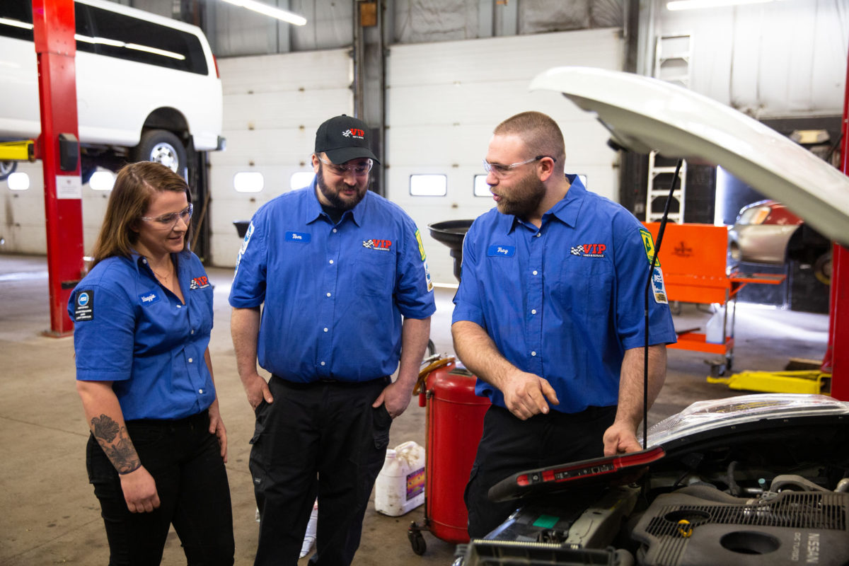 Technicians at VIP Tires & Service working on a car