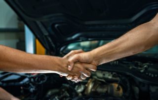 handshake at a repair shop