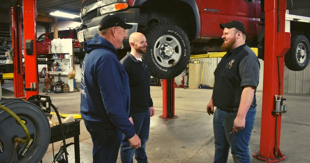 employees talking in an auto repair shop