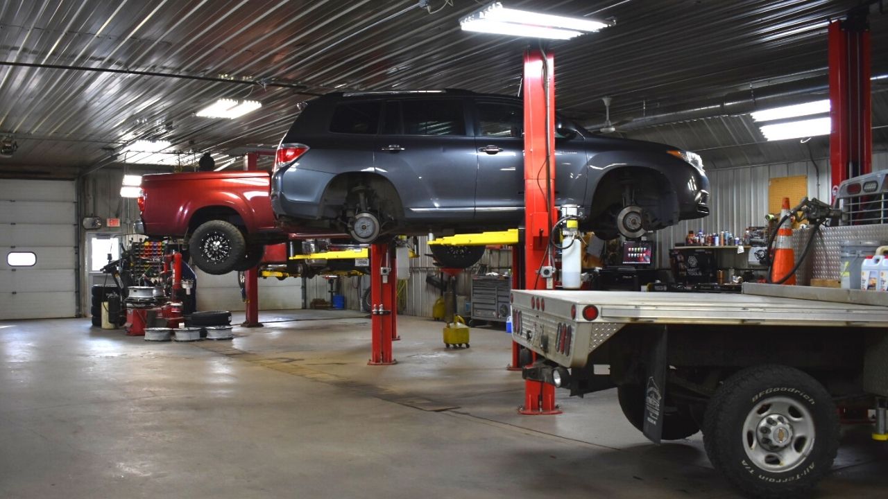 cars on a lift in a shop