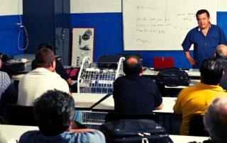 Automotive instructor teaching a class of students