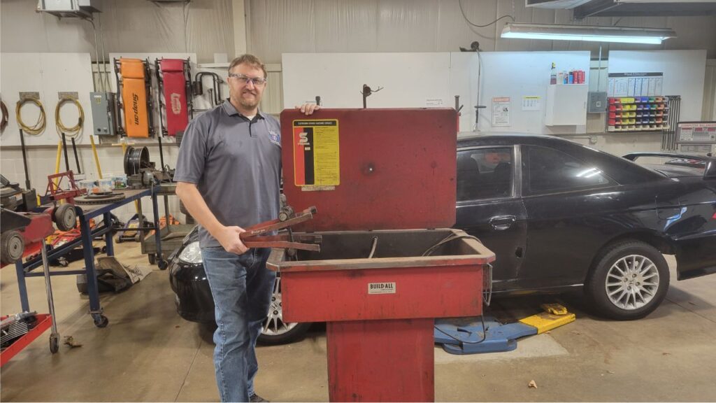 Matt, auto instructor, with equipment donated from local shop