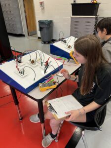 High school student with electrical board