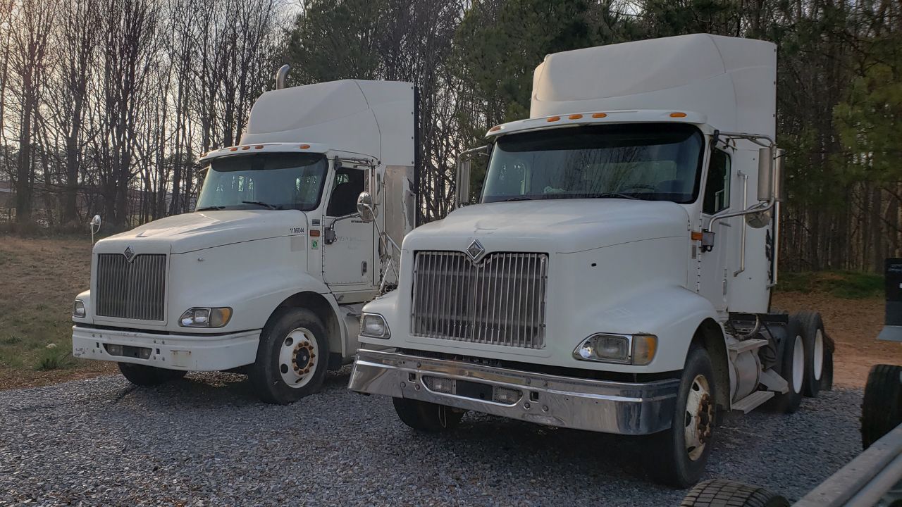 Picture of two of the four diesel trucks donated