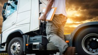 diesel mechanic in front of a truck