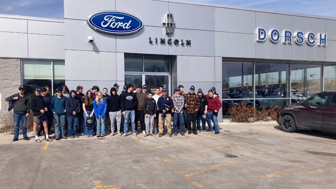 Auto students outside of dealership during visit